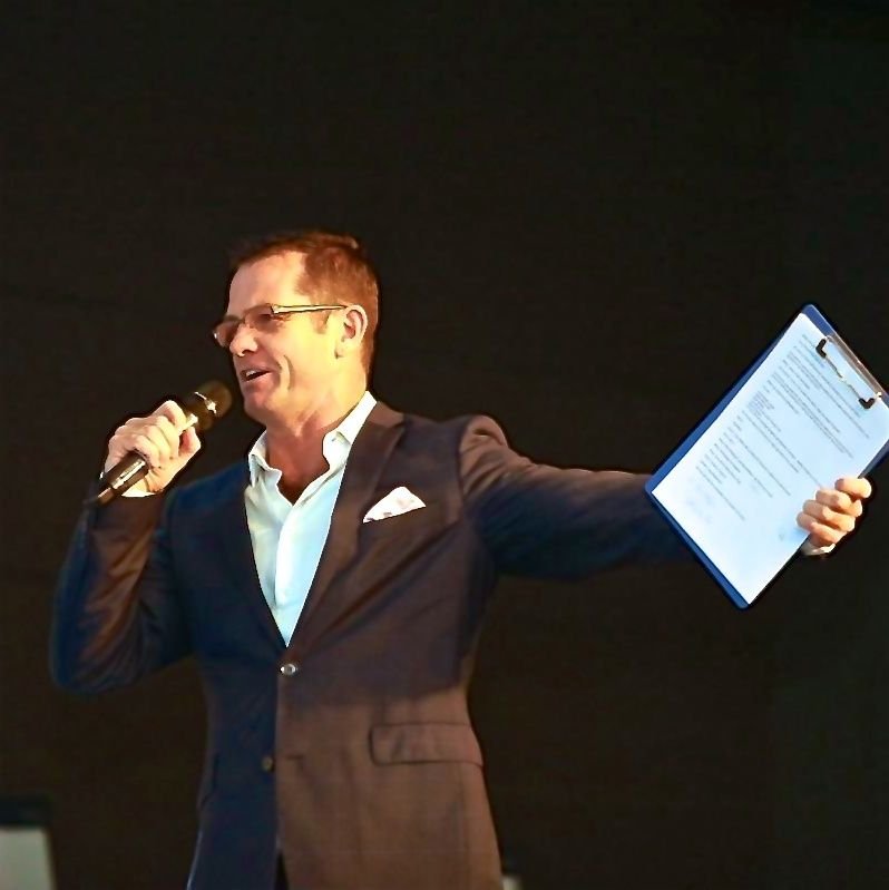 Shaun McEwan on the microphone, mid-flow at a live event