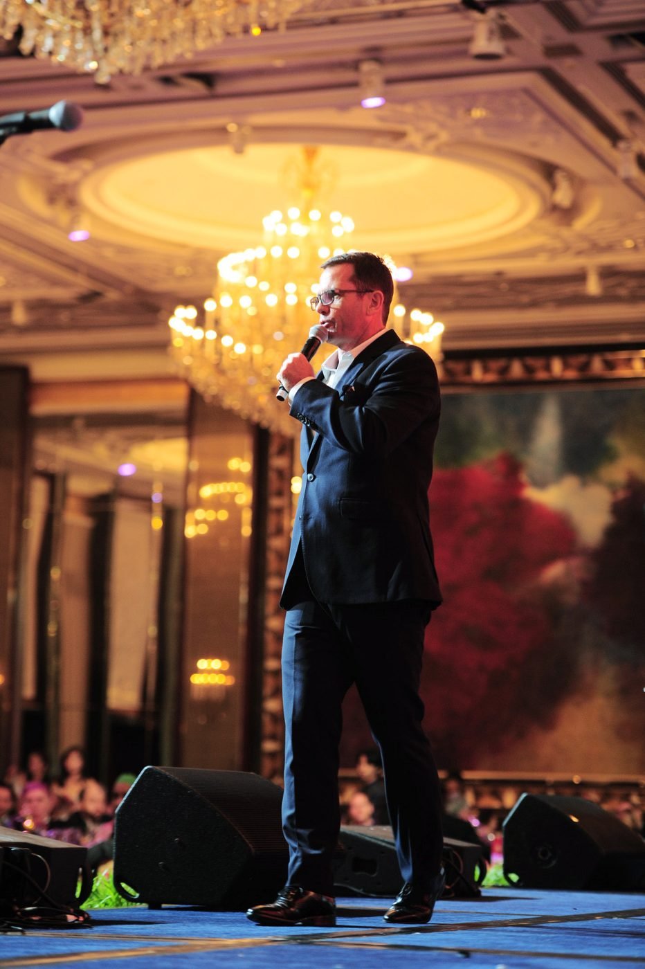 Shaun McEwan hosting a gala dinner in a grand ballroom